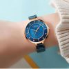 CURREN 9051 Women's Quartz Dress Watch - Golden White Blue watch with rose-gold accents on a wrist