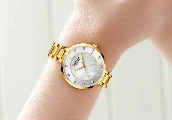 CURREN 9051 Women's Quartz Dress Watch - Golden White Gold watch with a white face worn on a wrist