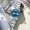 CURREN 9107 Women's Analog Quartz Watch - Silver Blue Silver watch with a blue face on a textured surface